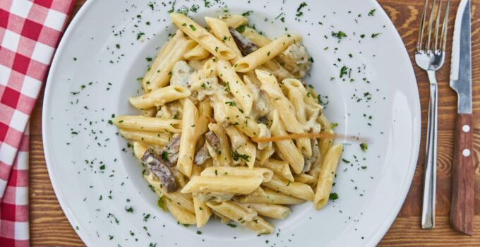 Flat Lay Photography of Pasta Served in White Plate