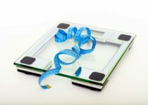 Blue Tape Measuring on Clear Glass Square Weighing Scale