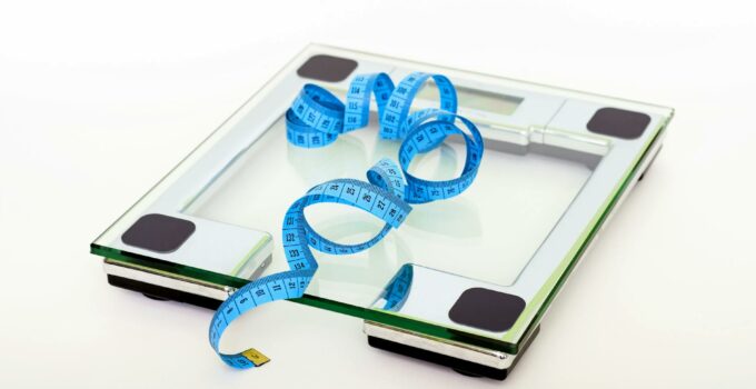 Blue Tape Measuring on Clear Glass Square Weighing Scale