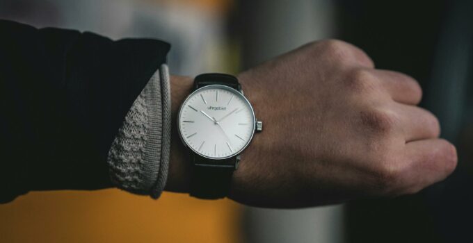 Person Wearing Round White Analog Watch at 10:09