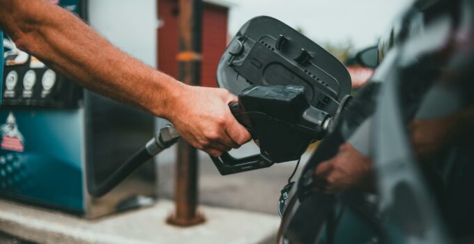 Person Putting Gasoline on a Vehicle