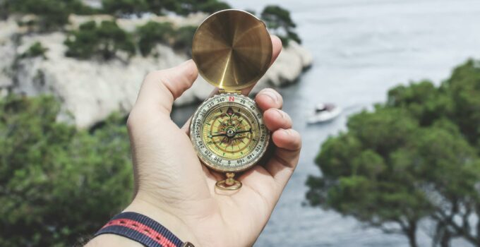 Person Holding Compass