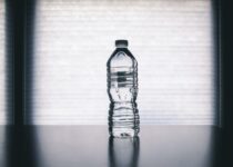 Clear Disposable Bottle on Black Surface
