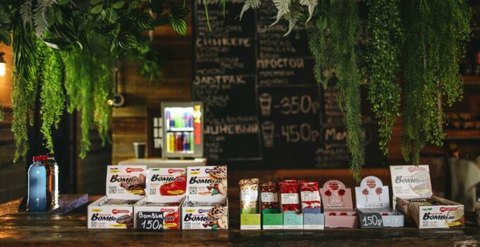 Bar with sweets and water decorated with plants