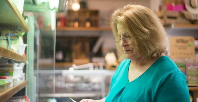 Woman Reading a List of Grocery