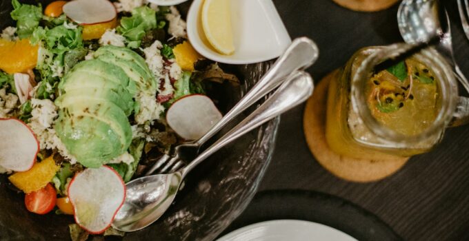 Tasty salad and smoothie on table