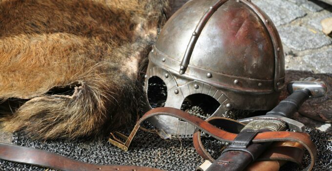 Black Steel Helmet Near Black and Gray Handle Sword