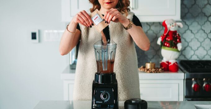 Womna Pouring Powder on the Blender