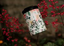 Reusable water bottle for travel near blooming flowers
