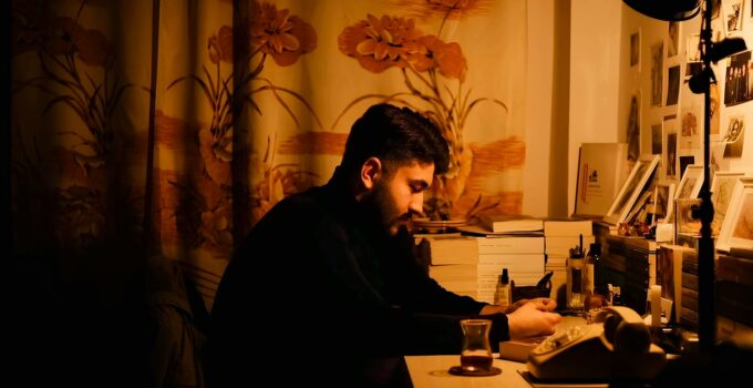 A man sitting at a desk in a dark room