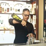 Barman preparing cocktail at counter