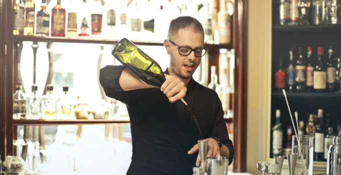 Barman preparing cocktail at counter