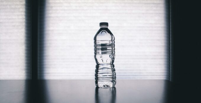 Clear Disposable Bottle on Black Surface